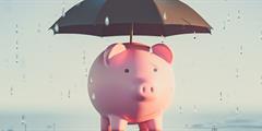 Piggy bank with umbrella in the rain